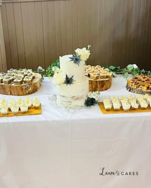 Wedding cake: A table with a cake and cupcakes on it