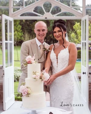 Wedding cake: A bride and groom cutting their wedding cake