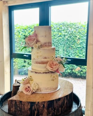 Wedding cake: A white wedding cake with pink flowers on top