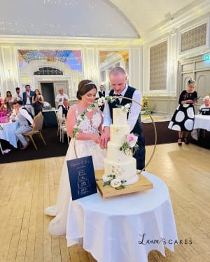 Wedding cake: A bride and groom cutting their wedding cake