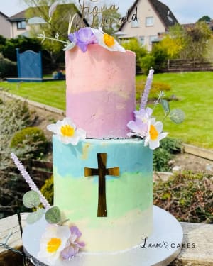 Celebration cake: A cross on top and flowers on the side