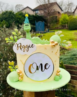 Celebration cake: A dinosaur on top of it