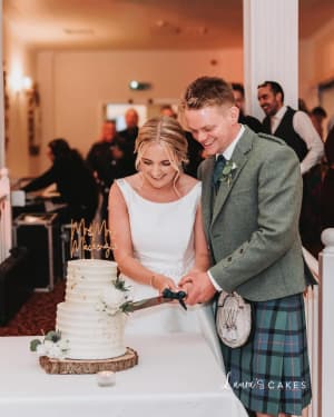 Wedding cake: A bride and groom cutting their wedding cake