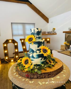 Wedding cake: Sunflowers and greene on top