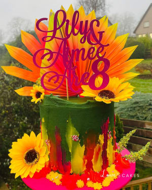 Celebration cake: A colorful cake topper and flowers