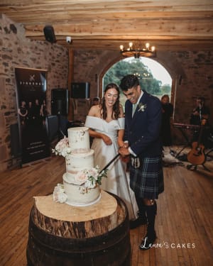 Wedding cake: A bride and groom cutting their wedding cake