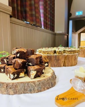 Wedding cake: A table with a bunch of brownies on it