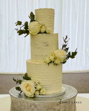 Wedding cake: A white cake with flowers on top