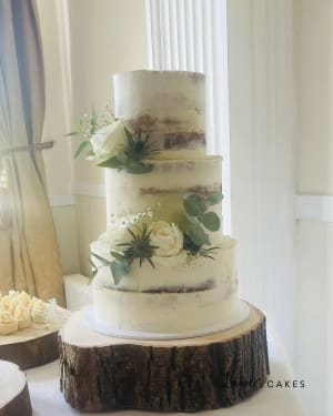 Wedding cake: A white wedding cake with flowers on top