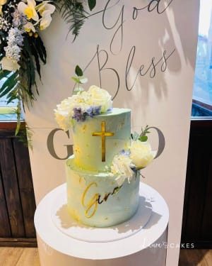 Celebration cake: A cross on top and flowers
