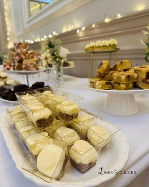 Wedding cake: A table with a plate of desserts and a glass of wine