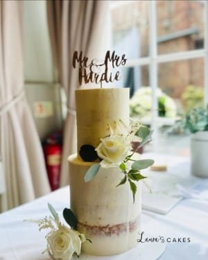 Wedding cake: White flowers and a cake topper