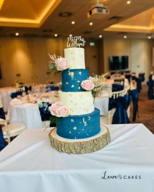 Wedding cake: A blue and gold wedding cake with flowers
