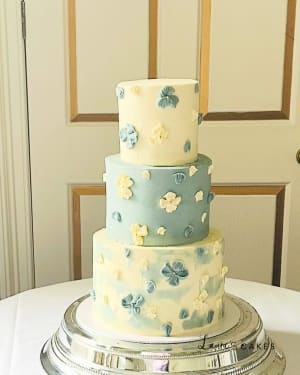 Wedding cake: A three tier cake with blue and yellow flowers