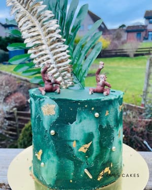 Celebration cake: A green cake with a small monkey on top