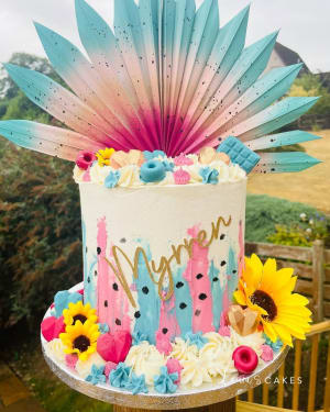 Celebration cake: A colorful cake topper and a flower arrangement