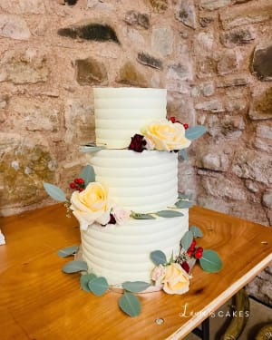 Wedding cake: A white cake with flowers on top