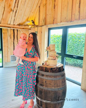 Wedding cake: A woman in a pink dress holding a cake