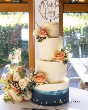 Wedding cake: A white wedding cake with a blue om om om om om om om om om om om om om om om om om om om om om