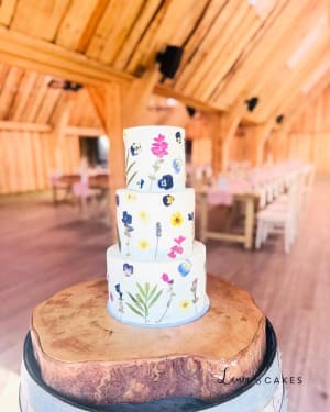Wedding cake: A white cake with colorful flowers on top