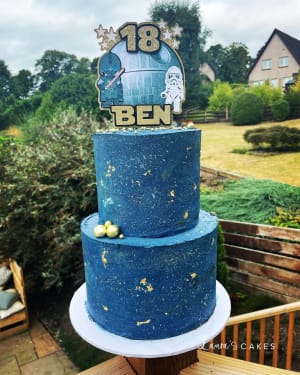 Celebration cake: A blue cake with a gold number on top