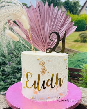 Celebration cake: A pink and gold cake with a feather on top