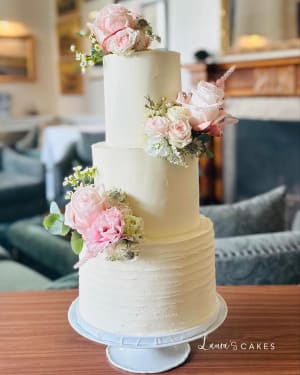 Wedding cake: A white cake with pink flowers on top