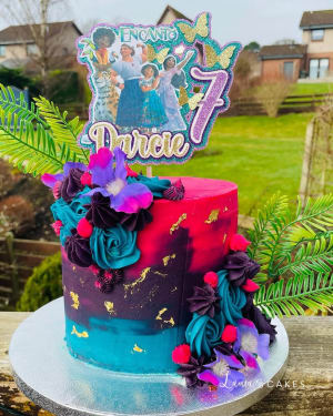 Celebration cake: A purple and blue cake topper and a purple and blue cake topper