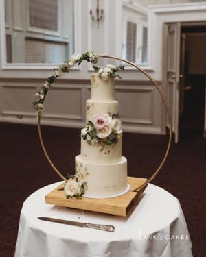 Wedding cake: A white wedding cake with flowers on top