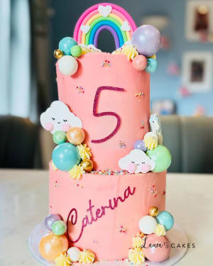 Celebration cake: A pink cake with a rainbow theme