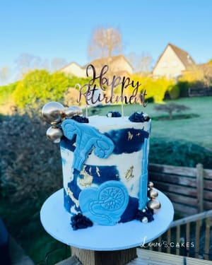 Celebration cake: A blue and white cake with a gold foil design