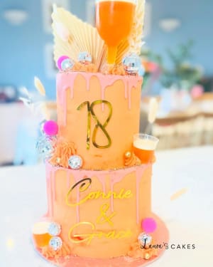 Celebration cake: A pink and orange design on it