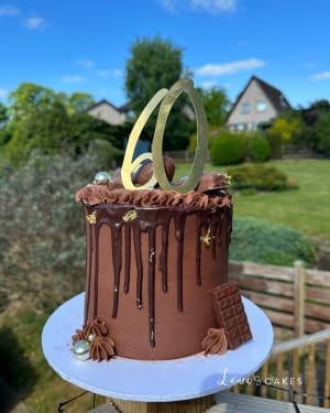 Celebration cake: A chocolate cake with chocolate drips and a knife