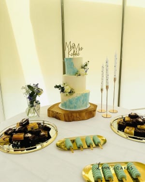 Wedding cake: A table with a cake and desserts on it