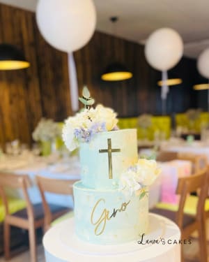 Celebration cake: A cross on top and flowers on top