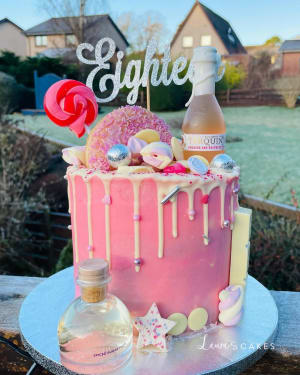 Celebration cake: A pink cake with white icing and pink icing on top