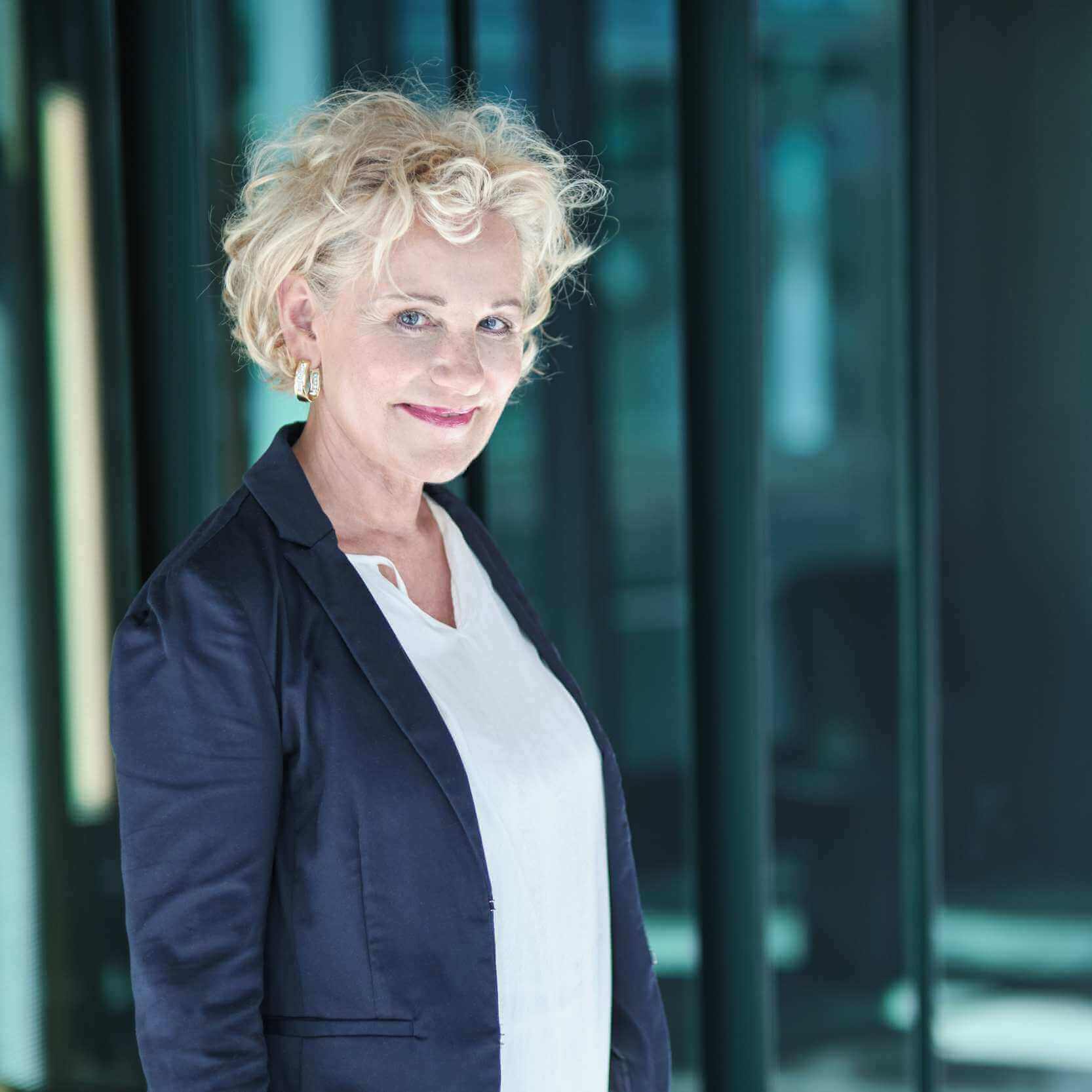 Rasmus Schübel Fotograf Münster Tamara Heuser Personal Branding professionelles Business Portrait Psychologin blaue Wand