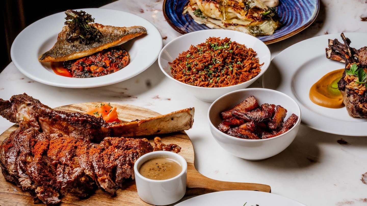A shared dinner spread with a main dish, sides and dessert.