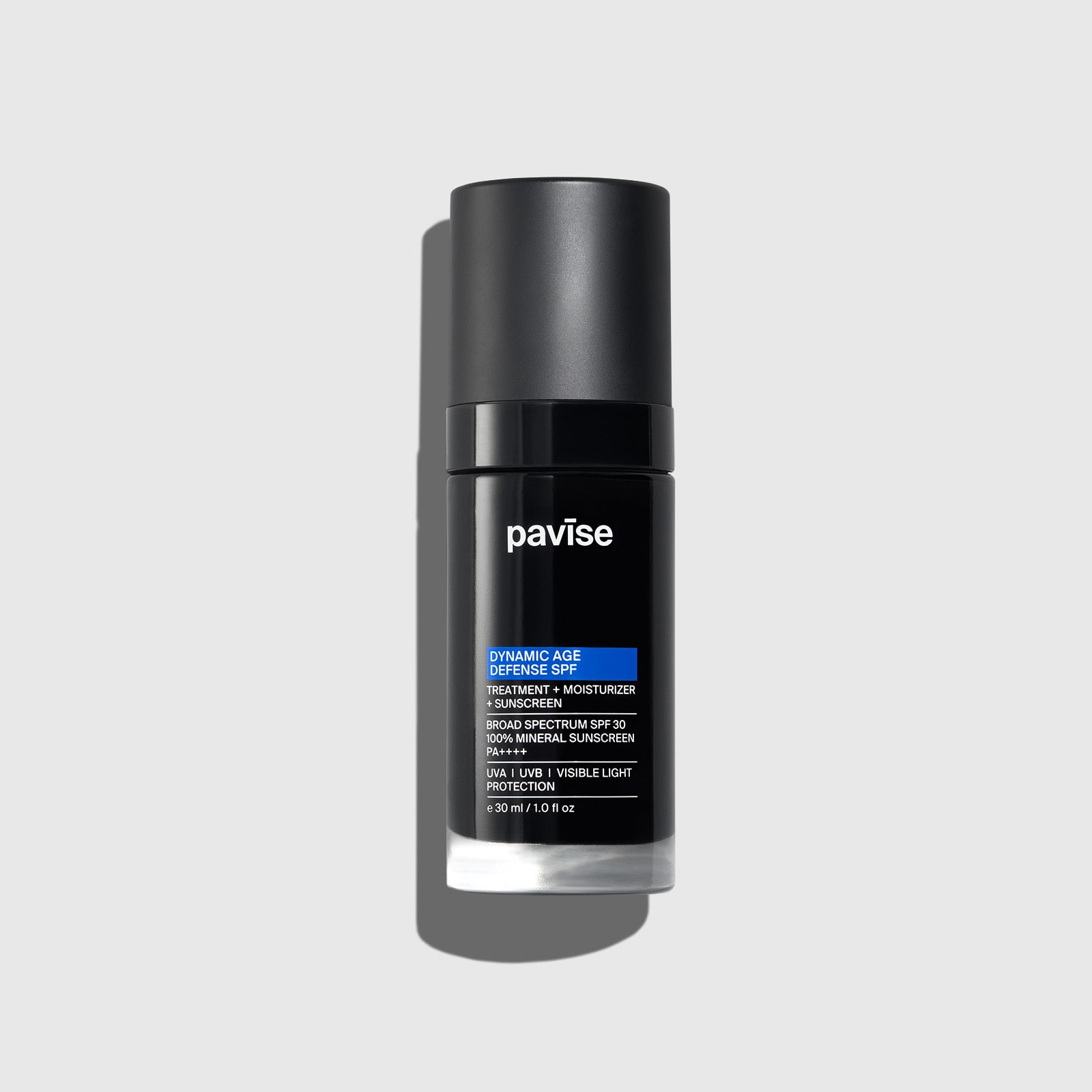Black cylindrical bottle with white cap and label featuring blue accent band for Pavise Dynamic Age Defense SPF sunscreen product