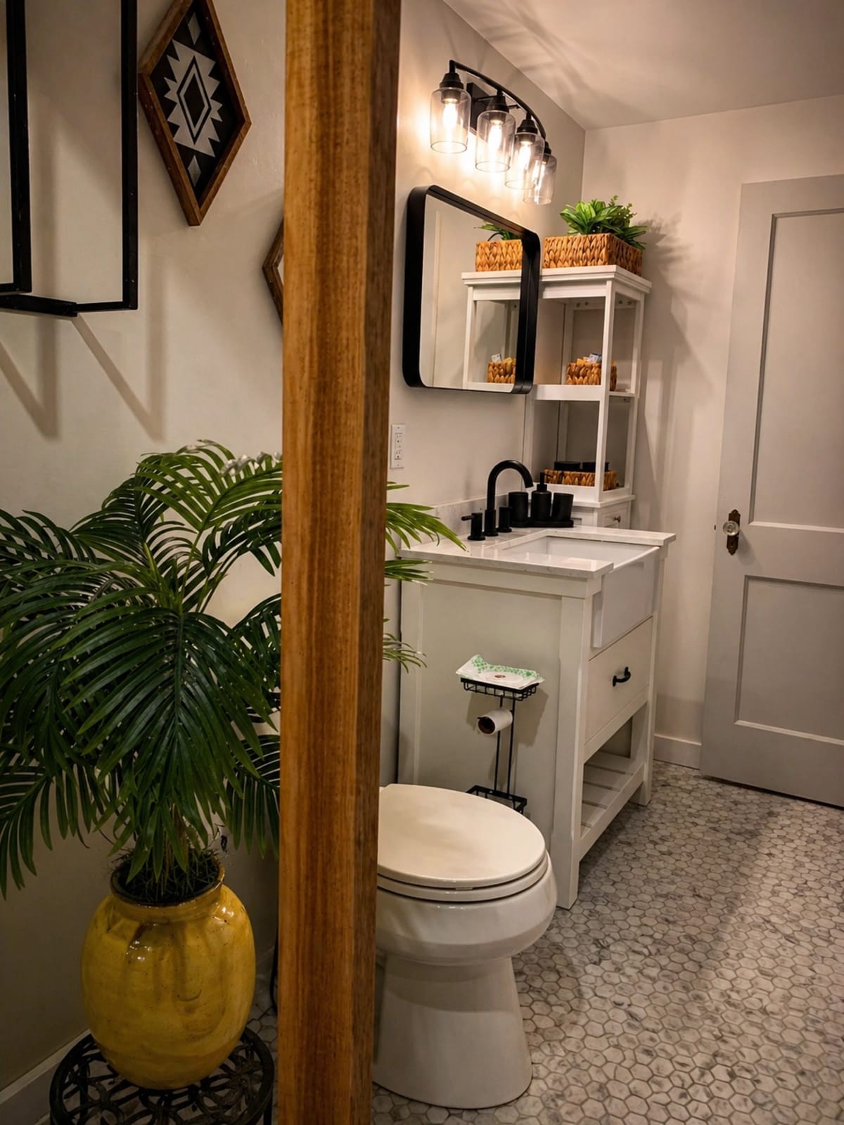 Bathroom vanity area with black fixtures, warm wood divider, and rustic camp decor