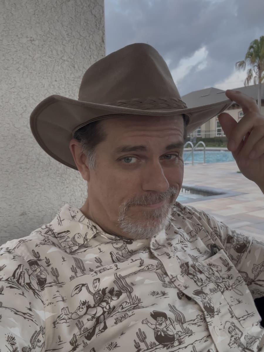 Selfie doing a hat tip while wearing an Aussie cowboy hat and Toy Story cowboy themed shirt Selfie doing a hat tip while wearing an Aussie cowboy hat and Toy Story cowboy themed shirt