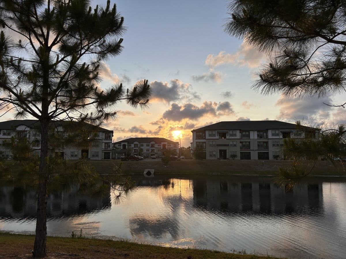 Sunset over the lake and apartment buildings Sunset over the lake and apartment buildings