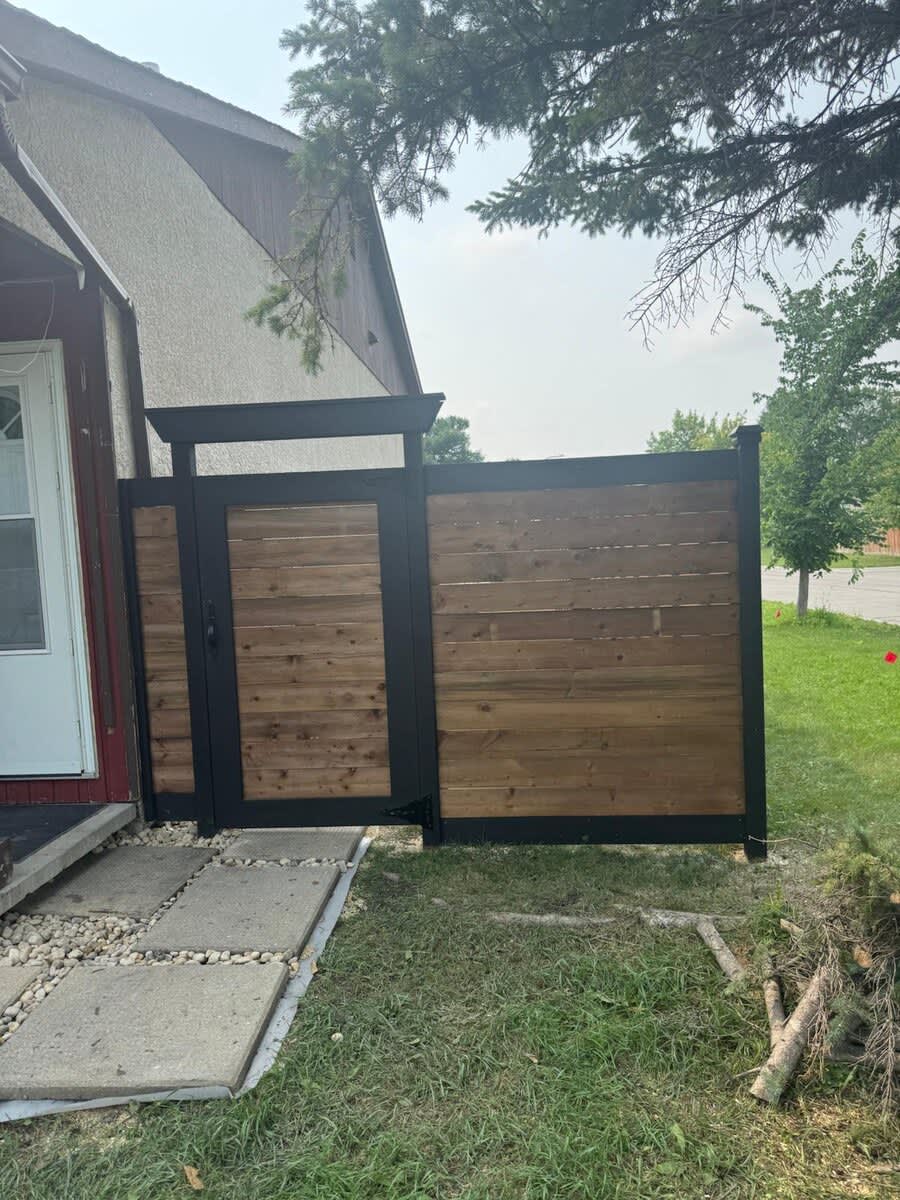 Horizontal wood fence and gate with black frame and pergola top