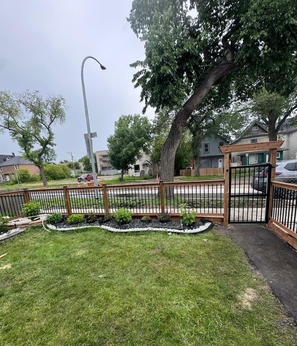 Wood and metal baluster fence with arbor gate