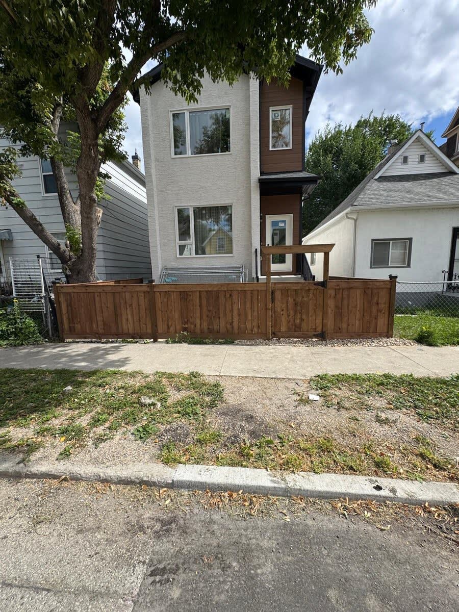 Wood front-yard fence with arbor gate