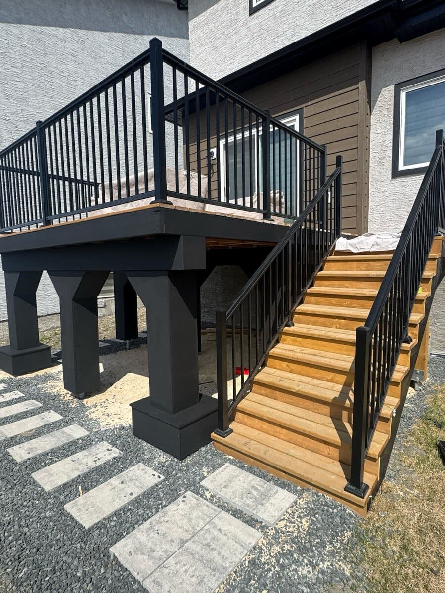 Two-tone deck with stairs and black railing