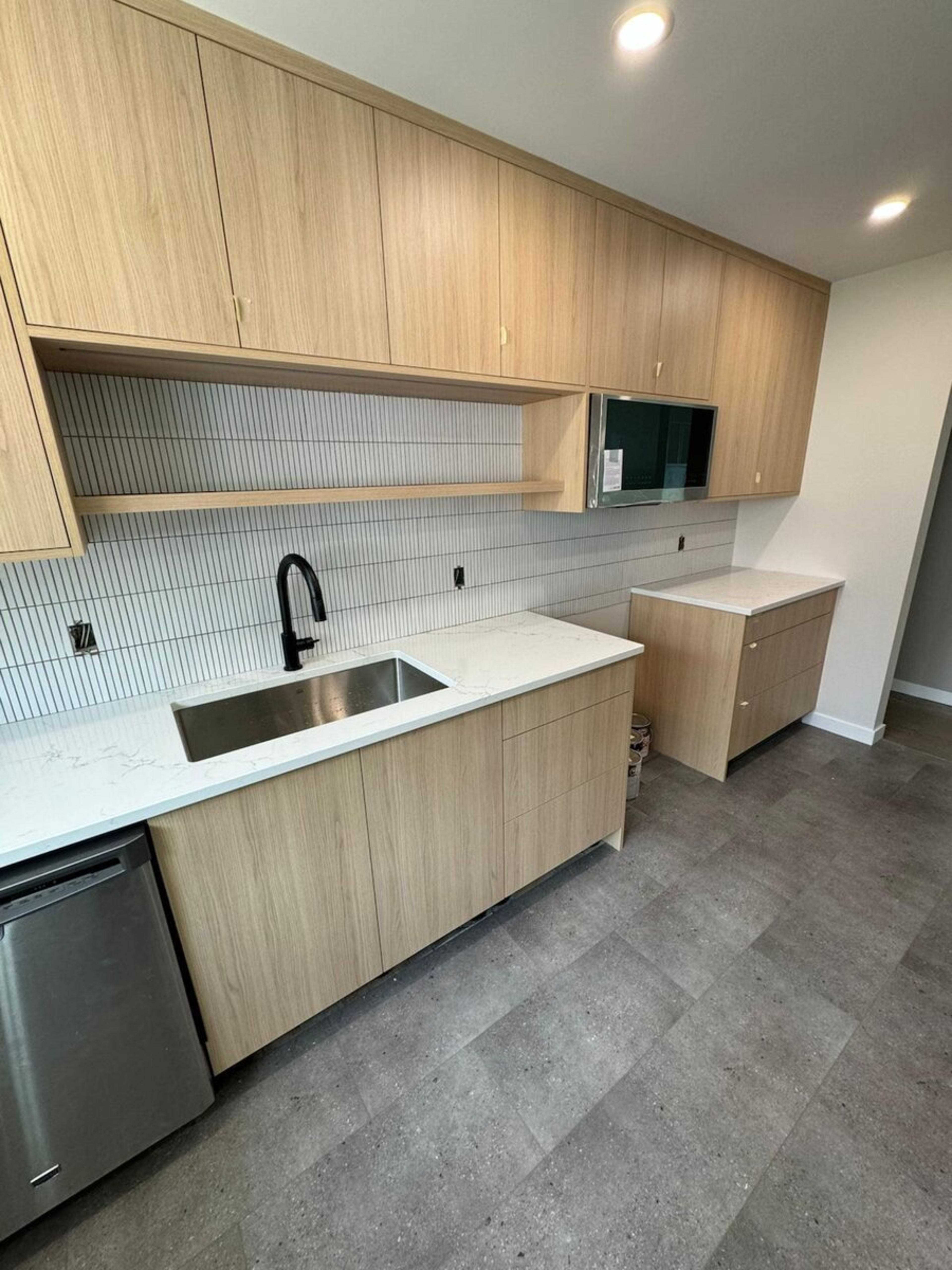 Natural wood kitchen with quartz countertops