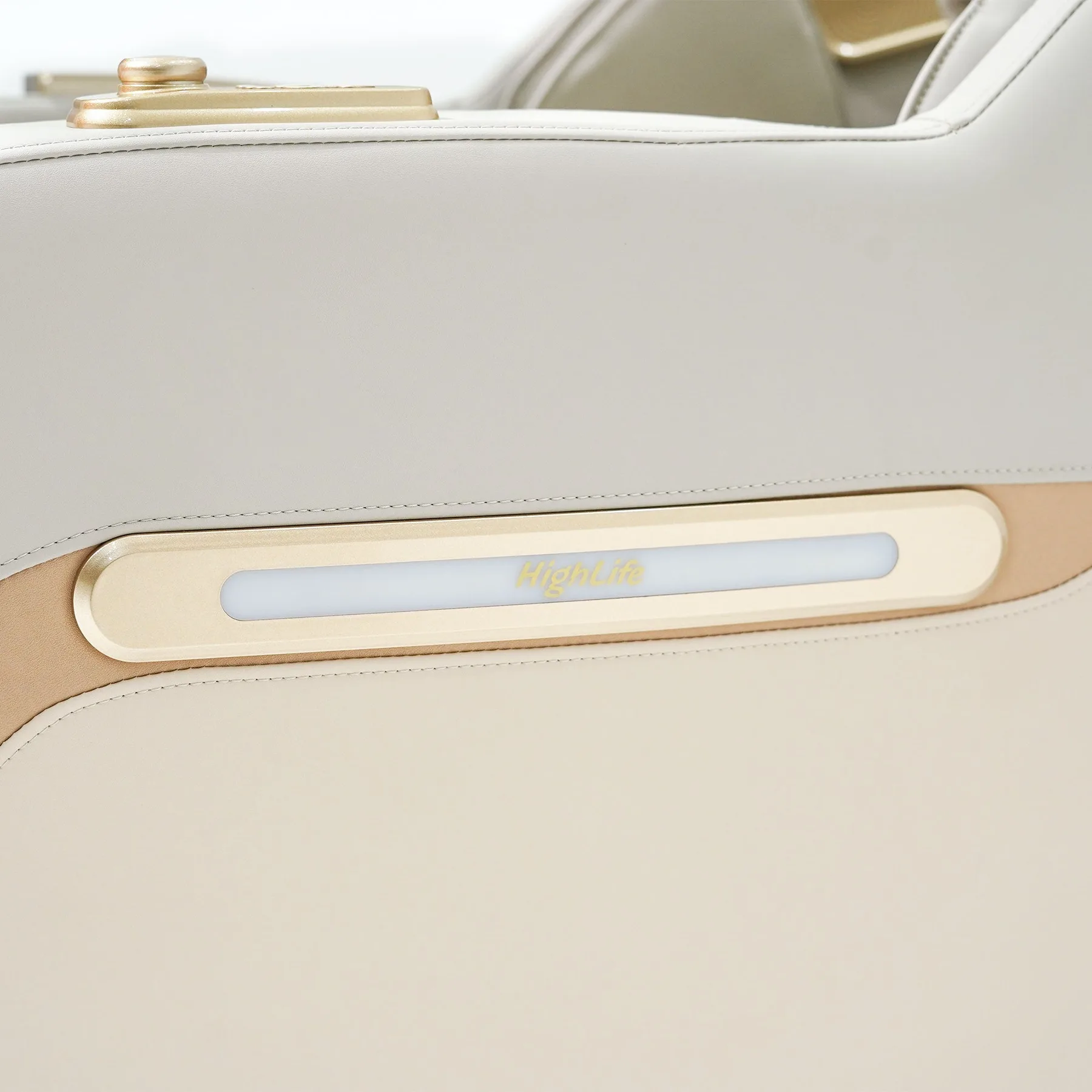 Wireless phone charging pad inset in the armrest