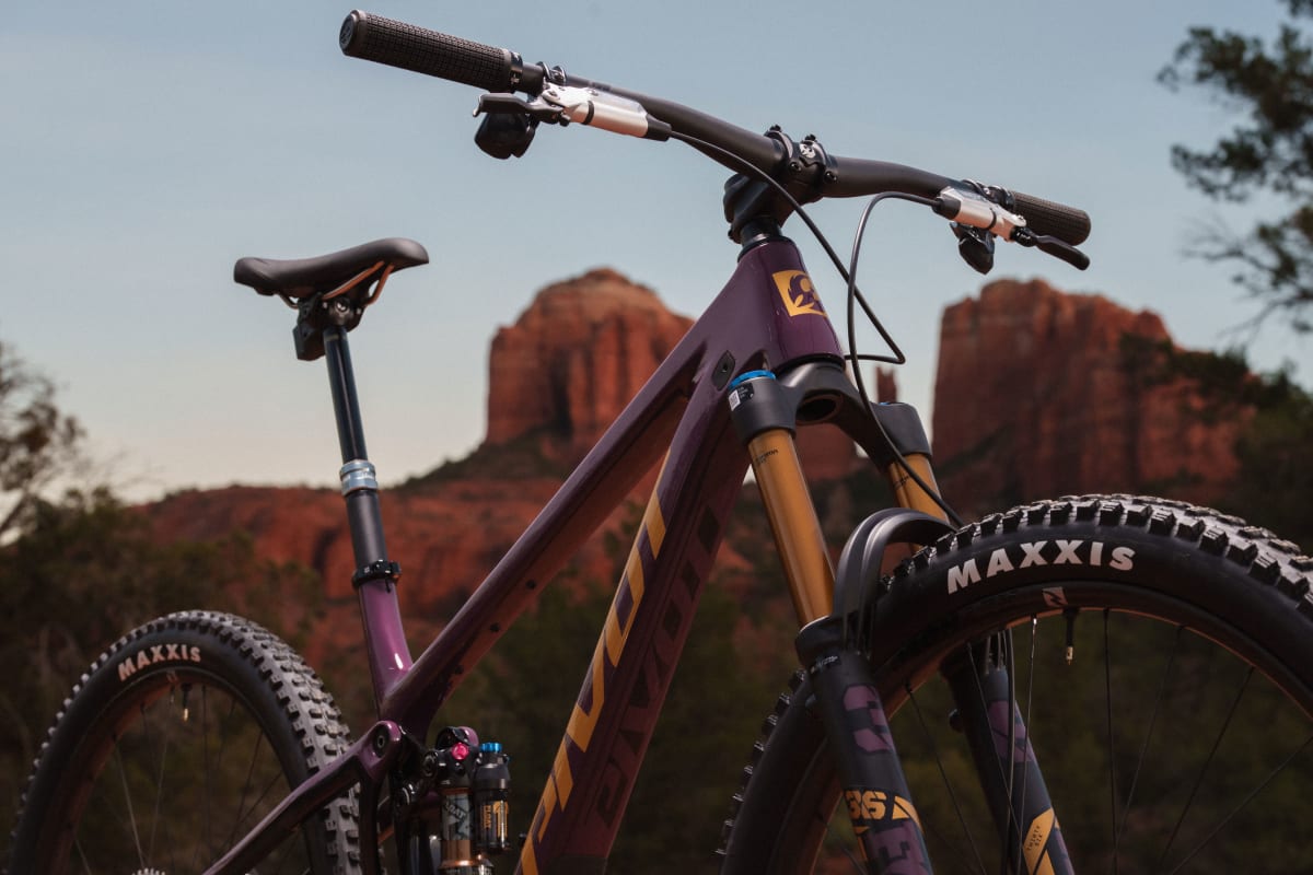 pivot trailcat lt slightly zoomed in shot feature the bike's head badge, top tube, down tube and shock imposed upon the Sedona cathedral style rocks in the background
