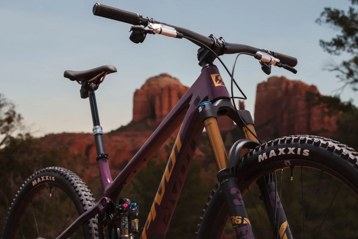 pivot trailcat lt slightly zoomed in shot feature the bike's head badge, top tube, down tube and shock imposed upon the Sedona cathedral style rocks in the background